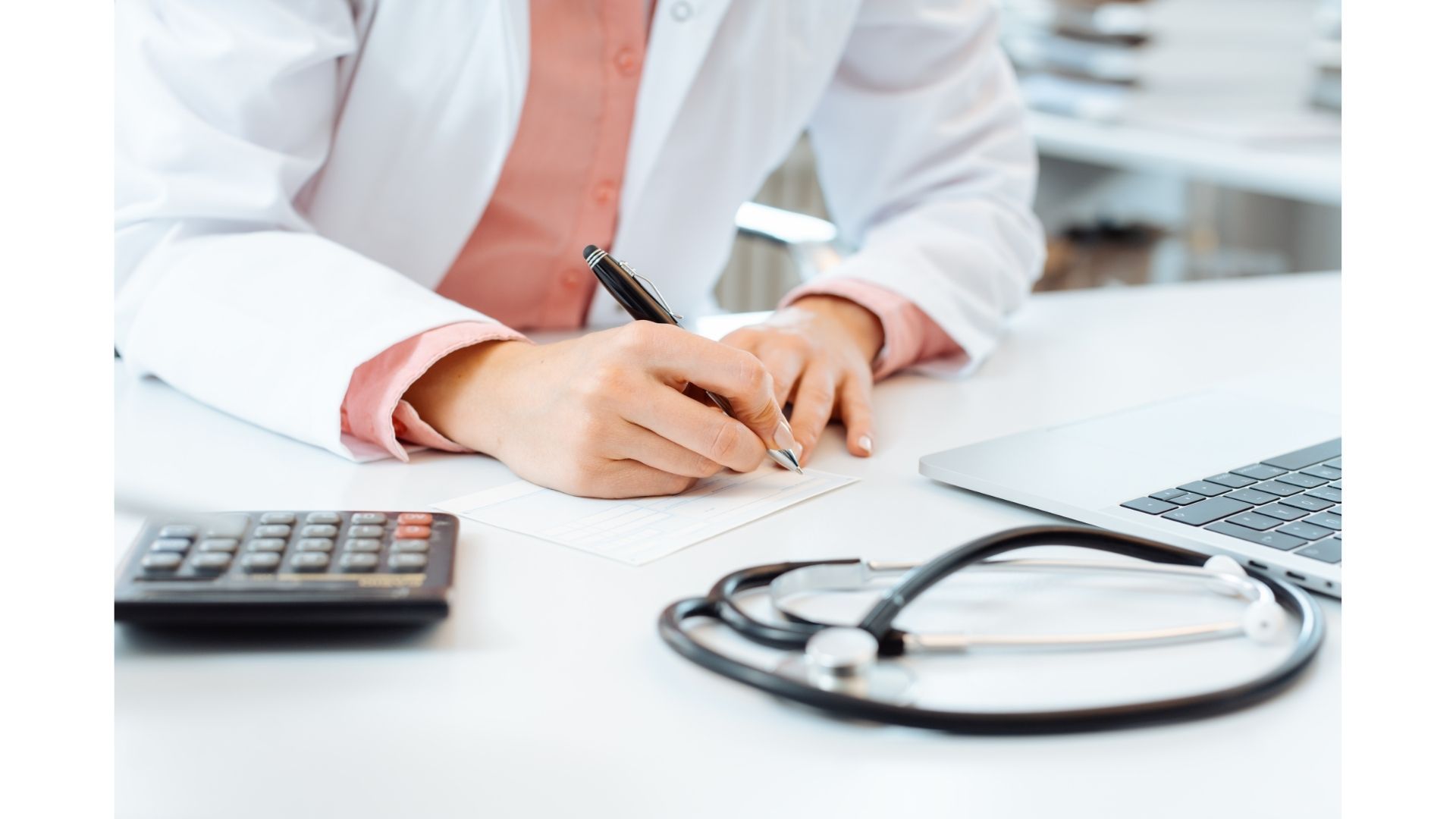 Close-up of stethoscope & taking notes