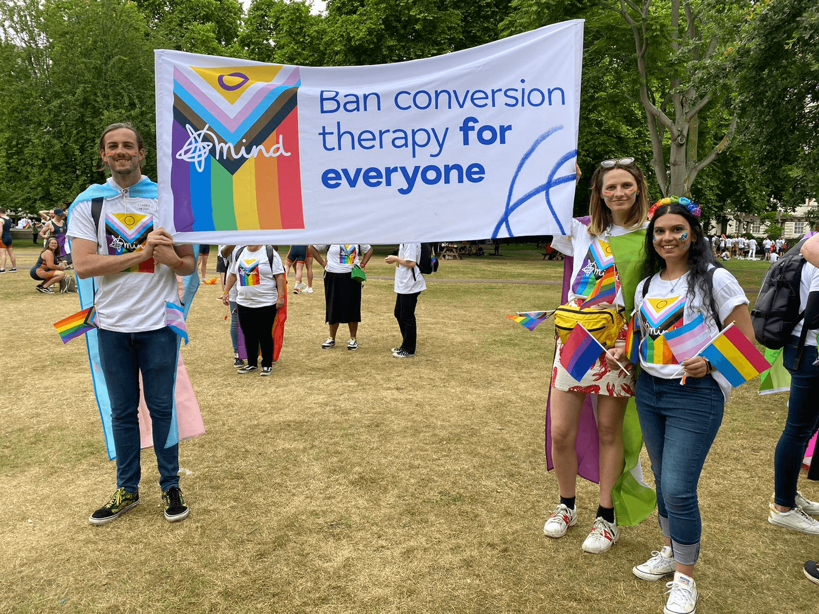 Mind in Harrow Staff holding pride flags and banner which says "Ban conversion therapy for everyone"